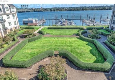 Experience elevated riverfront living in this top-floor