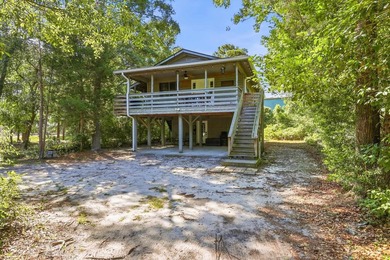 Tucked beneath a canopy of mature trees just minutes from the - photo 1