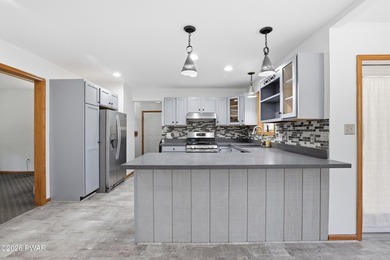 This beautifully maintained home sits on a 1-acre wooded - photo 12