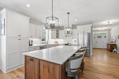 Luxury, low-maintenance living meets peaceful wooded privacy in - photo 3