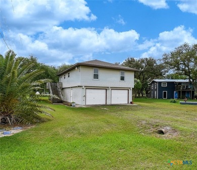 Bay breeze and shade trees await at 225 Swallow Dr. in gated - photo 1