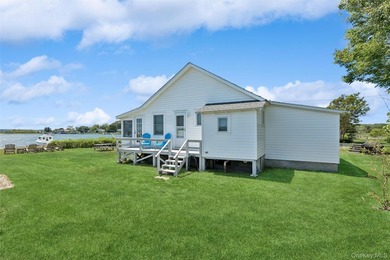 Tucked away in a secluded waterfront setting, this charming - photo 3
