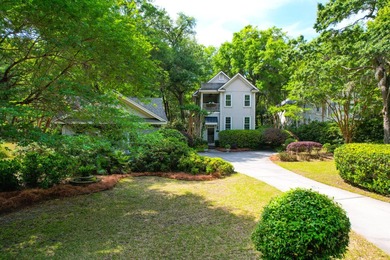 Nestled under mature oak trees and surrounded by gardens, you'll - photo 1