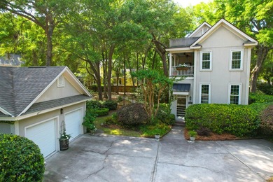 Nestled under mature oak trees and surrounded by gardens, you'll - photo 2
