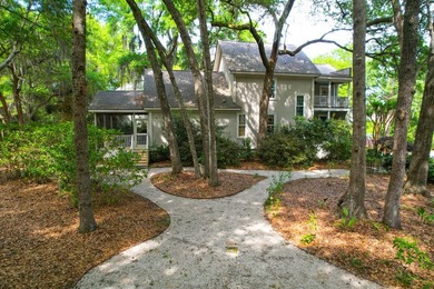 Nestled under mature oak trees and surrounded by gardens, you'll - photo 5