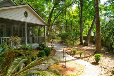 Nestled under mature oak trees and surrounded by gardens, you'll - photo 7