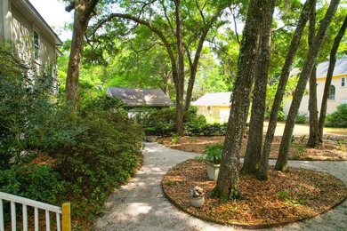Nestled under mature oak trees and surrounded by gardens, you'll - photo 8