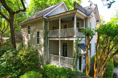 Nestled under mature oak trees and surrounded by gardens, you'll - photo 9