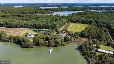 Set along the peaceful waters of Caulk Cove, this extraordinary - photo 8