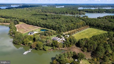 Set along the peaceful waters of Caulk Cove, this extraordinary - photo 9