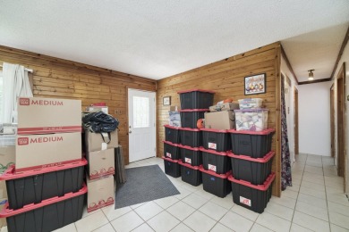 With its knotty pine wood finishes and tree shaded setting, this