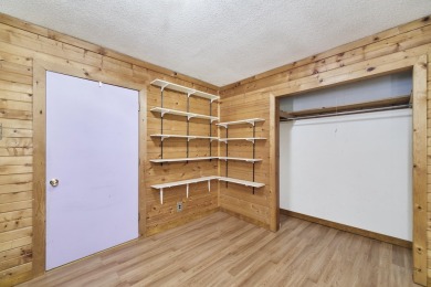 With its knotty pine wood finishes and tree shaded setting, this