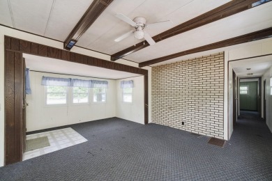 With its knotty pine wood finishes and tree shaded setting, this