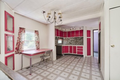 With its knotty pine wood finishes and tree shaded setting, this