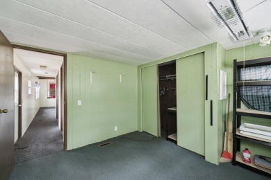 With its knotty pine wood finishes and tree shaded setting, this