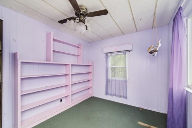 With its knotty pine wood finishes and tree shaded setting, this