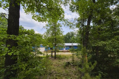 With its knotty pine wood finishes and tree shaded setting, this