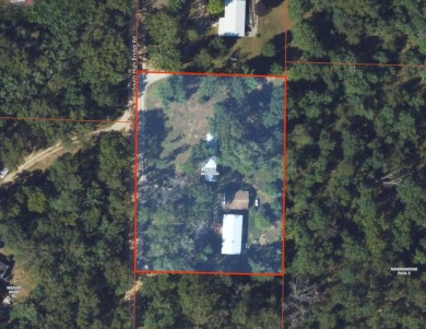 With its knotty pine wood finishes and tree shaded setting, this