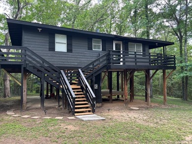 Private East Texas retreat nestled among the trees on 1.24 - photo 1