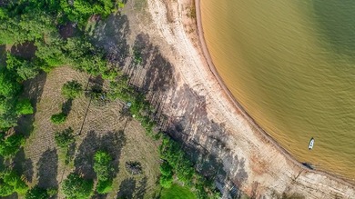 Discover 4.5 acres of cleared waterfront on the shores of Lake - photo 7