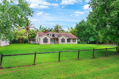 Set on a beautifully manicured and fenced 1.15-acre lot, this - photo 1