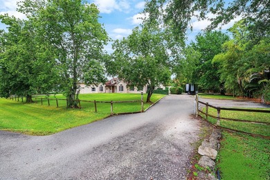 Set on a beautifully manicured and fenced 1.15-acre lot, this - photo 2
