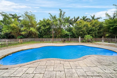 Set on a beautifully manicured and fenced 1.15-acre lot, this - photo 3