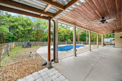 Set on a beautifully manicured and fenced 1.15-acre lot, this - photo 4