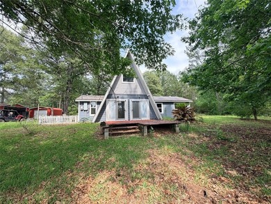Tucked away on 7.6+ acres of unrestricted, lakefront land on - photo 2
