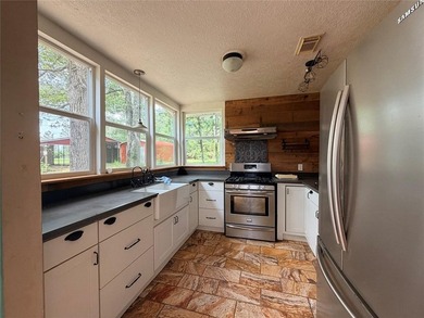 Tucked away on 7.6+ acres of unrestricted, lakefront land on - photo 3