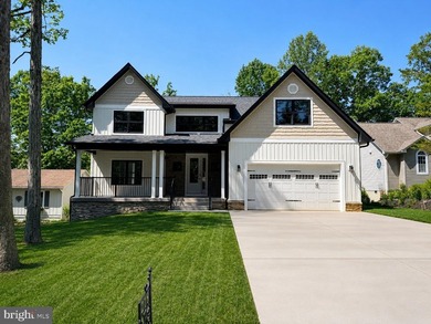 Nestled in the prestigious Lake of the Woods community, this - photo 1