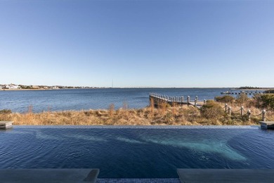 Set on 175 feet of private sandy beachfront with a 136' dock - photo 4