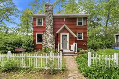 Set on nearly an acre in North Kingstown, this 3-bedroom, 1-bath - photo 1