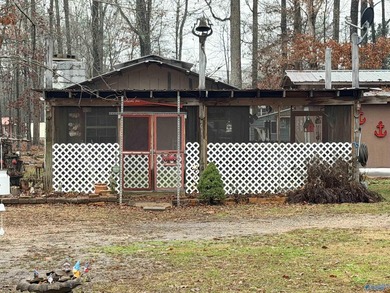 Make this cabin-style tiny home your lake area retreat. It sits - photo 1