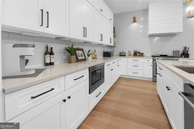 Tucked in the heart of Bridgemill, this luxury townhome lives - photo 5
