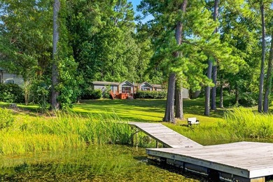 Discover the beauty of waterfront living on Lake Pinkston in - photo 1