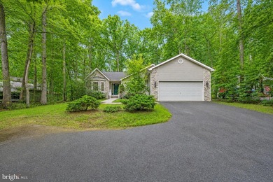 Nestled among mature green trees in the gated Lake of the Woods - photo 4