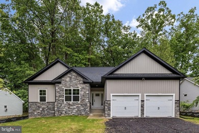 Nestled in the serene Lake of the Woods community, this stunning - photo 1