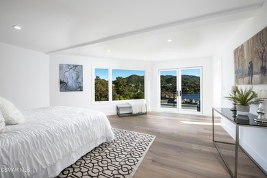 A modern residence defined by glass, light, and landscape. - photo 11