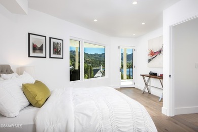 A modern residence defined by glass, light, and landscape. - photo 12