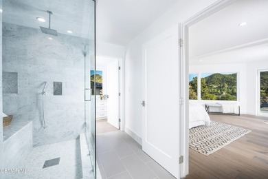 A modern residence defined by glass, light, and landscape. - photo 15