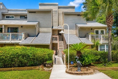 Exceptional marsh-front views, a spacious two-story layout, and - photo 1