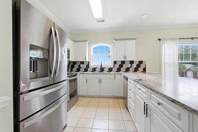 Welcome to this updated 3-bedroom, 2-bath end-unit condo in The - photo 9