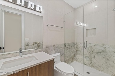An elegant 8 bedroom, 5 bathroom coastal residence with a - photo 3
