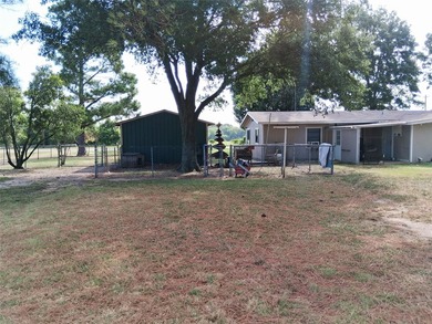 This quaint 2-bedroom, 2-bath home sits on nearly one acre and - photo 3