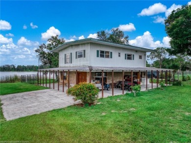 RARE FIND! Set on nearly 3 acres on Lake Persimmon, ZONED AG - Lake Home For Sale in Lake Placid, Florida