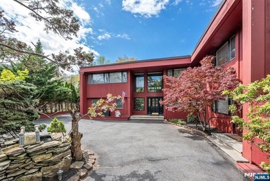 Set on a private and beautifully landscaped .8-acre property - photo 2