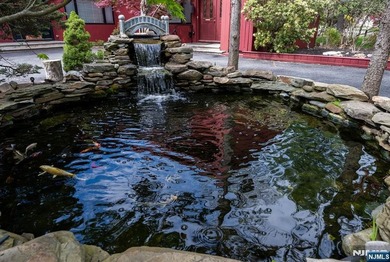 Set on a private and beautifully landscaped .8-acre property - photo 3