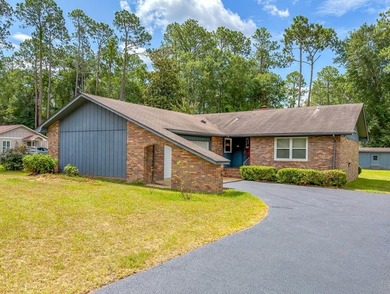 BRICK BEAUTY ON 0.5 ACRES! Welcome home to this charming - photo 1