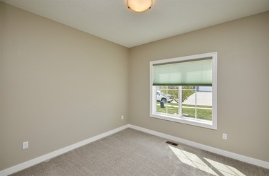 55+ Low Maintenance Living in Huxley! This townhome boasts over